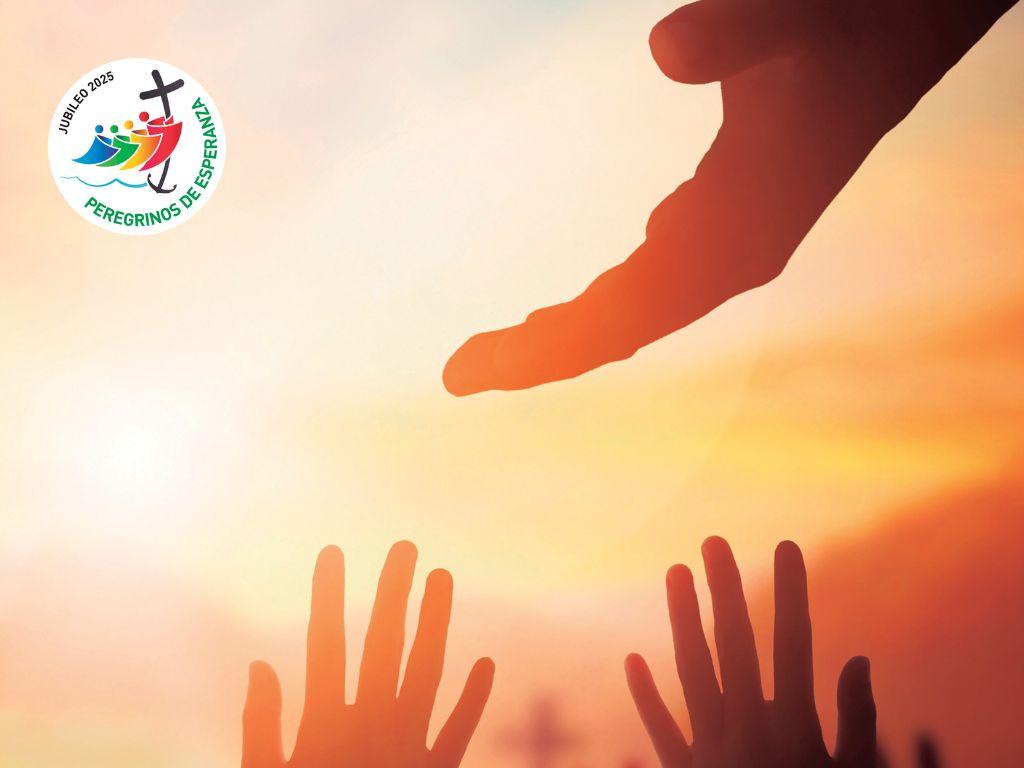 imatge de dos mans intentant arribar a una tercera, amb una posta de sol darrere i el logotip del Jubileo